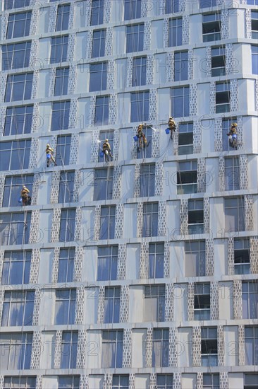 Window cleaners working on the facade of a skyscraper