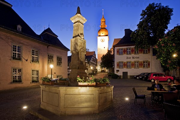 Maximilian Fountain in Alter Markt square with the old town hall and the bell tower at dusk