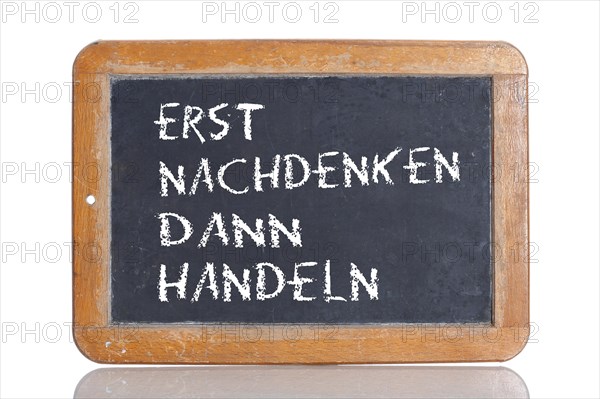 Old school blackboard with the phrase ERST NACHDENKEN DANN HANDELN