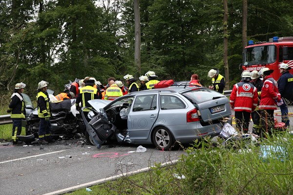 Rescue workers from the fire brigade and the German Red Cross in action at a traffic accident on federal road 327