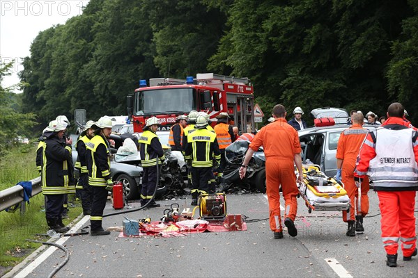 Rescue workers from the fire brigade and the German Red Cross in action at a traffic accident on federal road 327