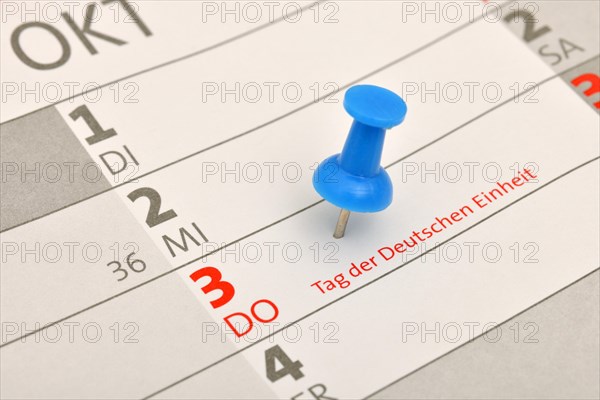 Calendar with a push pin marking 'Tag der Deutschen Einheit'