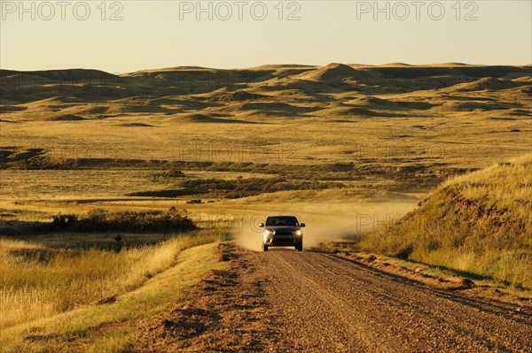 Car on a dirt road on the prairie