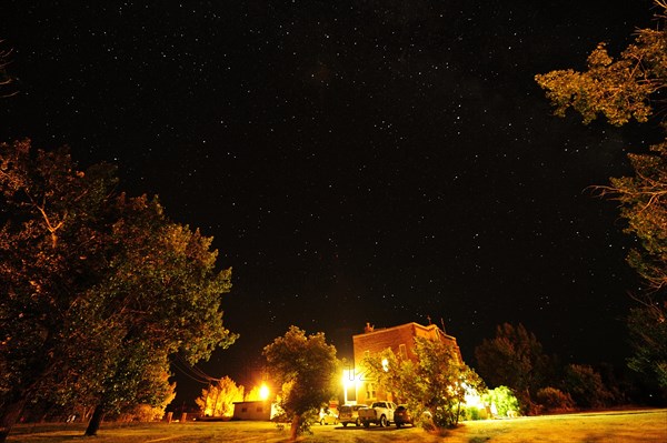 Starry sky over a small village in the middle of the prairies