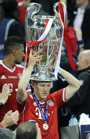 Bastian Schweinsteiger holding the trophy