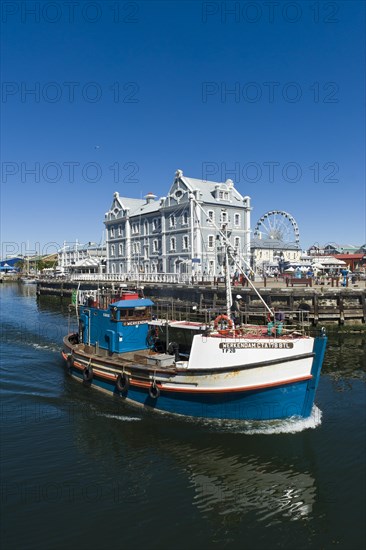 Fishing cutter in front of the African Trading Port building