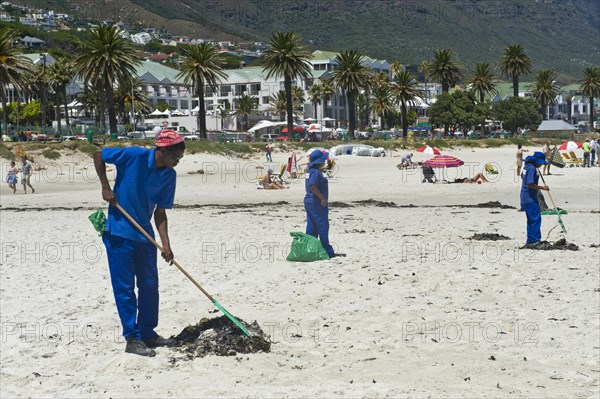 Workers cleaning Camps Bay Beach