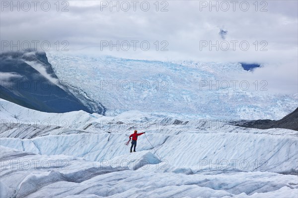 Mountaineer standing on a glacier tongue