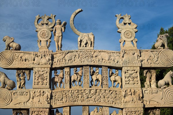 Toran or sacred gateway with stone reliefs at the Buddhist stupa