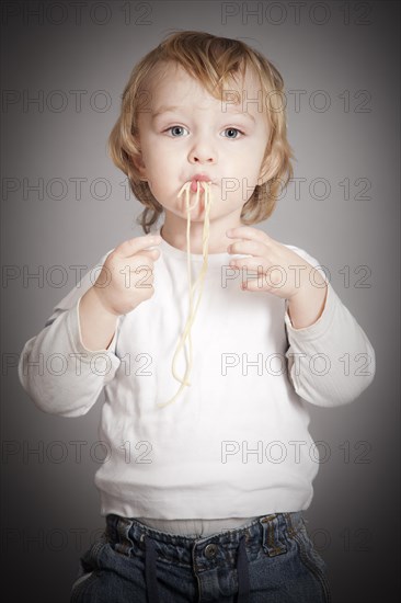 Boy eating spaghetti