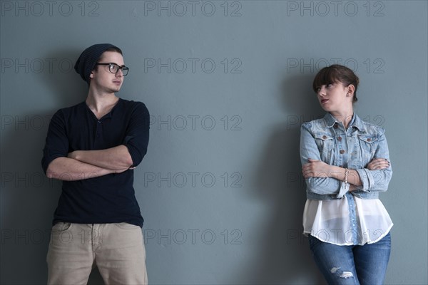 Young couple leaning on a wall