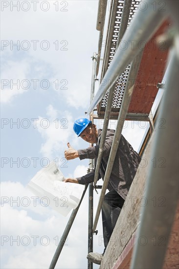 Satisfied construction manager making a thumbs-up gesture