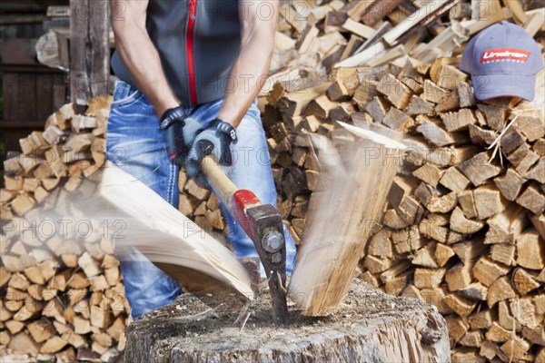 Young man chopping wood