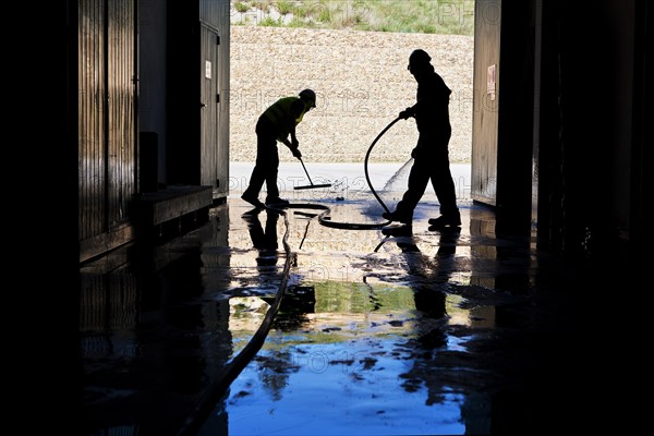 Workers cleaning a hall