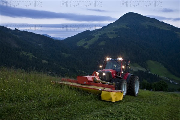 Tractor mowing hay