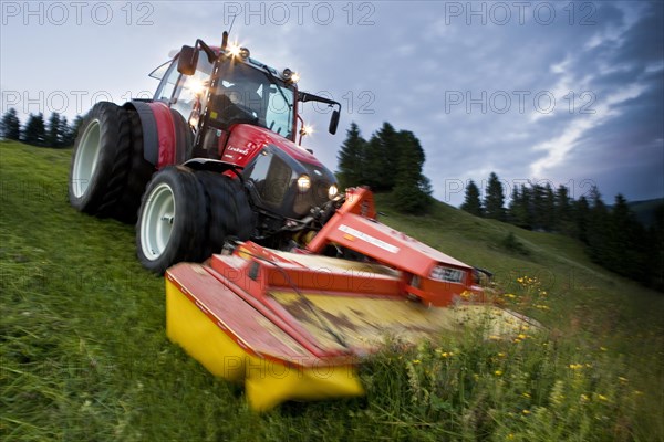 Tractor mowing hay