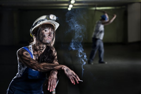 Female mine worker holding a cigarette