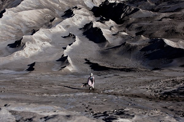 Man bringing a sacrificial offering to Mount Bromo volcano