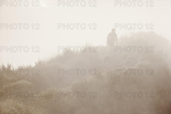 Hiker in the mist on Gunung Agung volcano