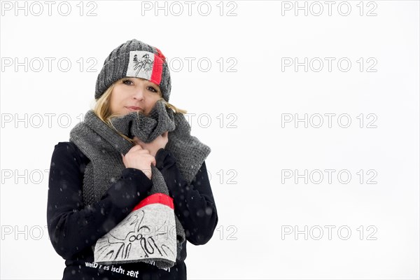 Young woman snuggling up in her shawl