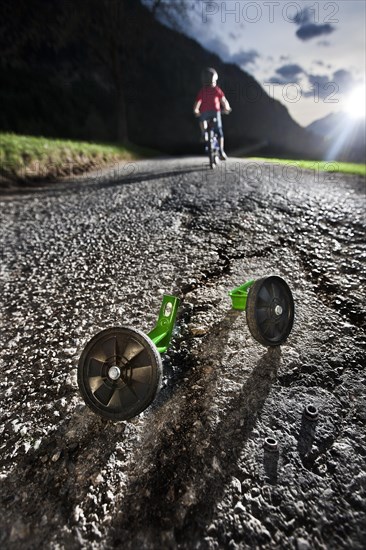 Boy riding a bicycle for the first time without training wheels