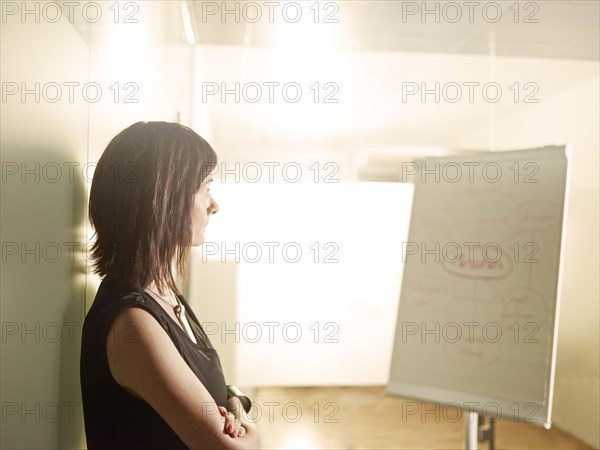 Woman standing with her arms crossed in an office