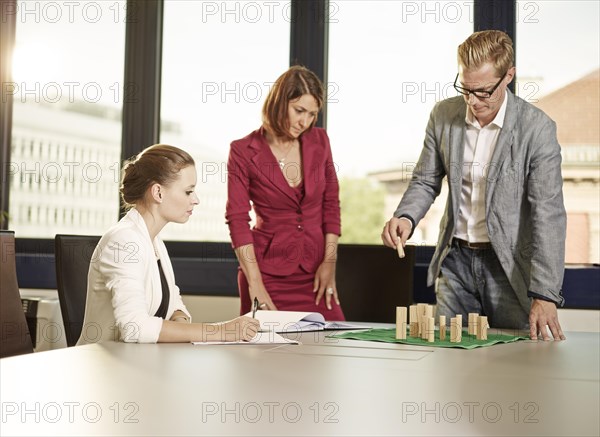 Business coach with clients using a system board