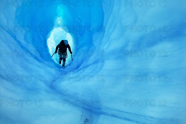 Ice climbing in an ice cave or glacier cave