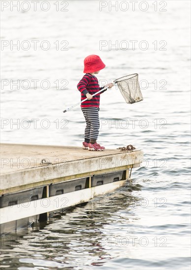 Child standing on jetty
