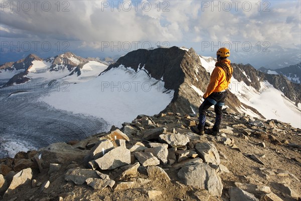 Mountain climber standing at the summit of Wilder Pfaff Mountain looking towards Alto Adige