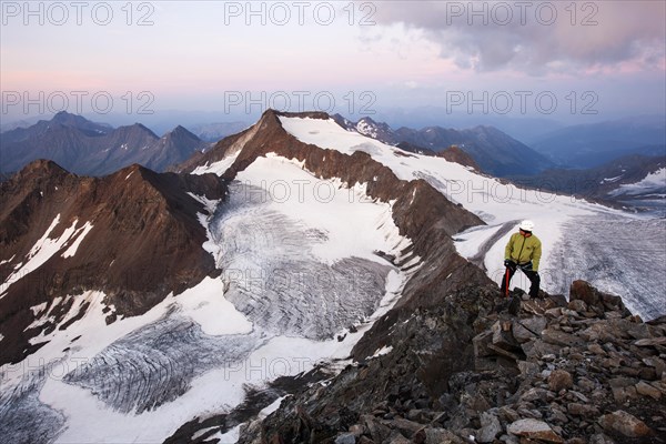 Mountain climber standing at the summit of Wilder Pfaff Mountain looking towards Alto Adige
