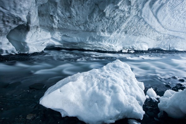 Glacial stream flowing through an ice cave of Matanuska Glacier