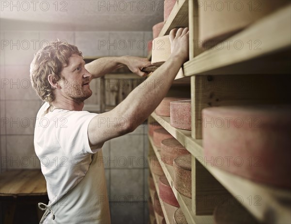 Dairyman storing his mountain cheese