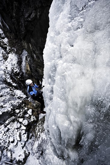 Ice climber climbing a frozen waterfall