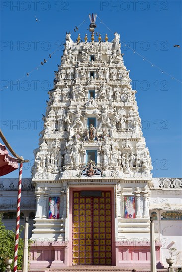 Depiction of gods and figures in white marble on a shikhara tower of a Hindu temple