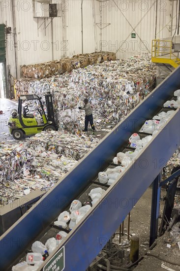 Low-wage workers sort paper