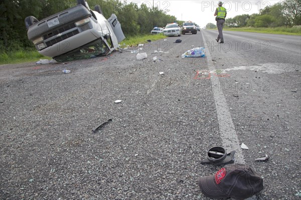 A baseball cap lying on the road after a van holding 26 undocumented immigrants from Central America overturned on Texas Highway 285