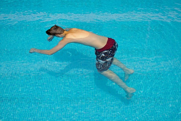 Motionless boy in a swimming pool