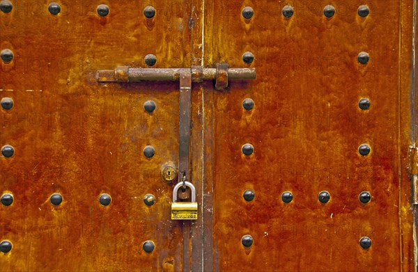 Lock and bar on an old metal door