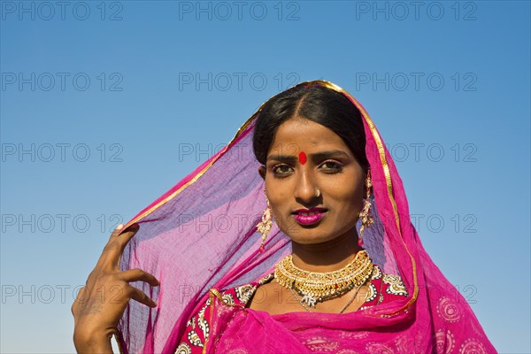 Young Indian woman with pink scarf and jewellery