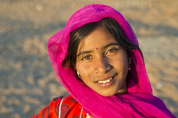 Smiling young woman with a headscarf and a bindi on her forehead