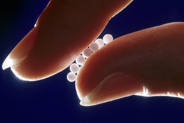 Globules held between fingers