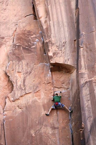 Rock climber climbing a rock wall