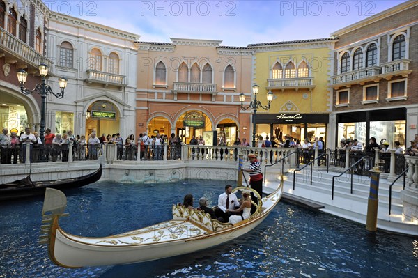 Tourists in a replica of Venetian streets under an artificial sky