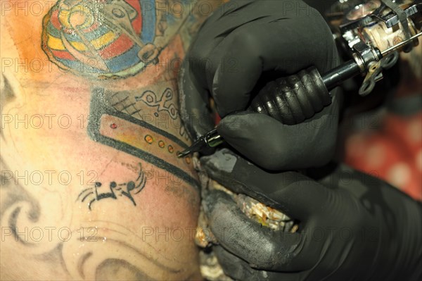 A young man is getting a tattoo