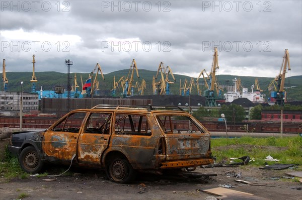 Scrap car next to a railroad