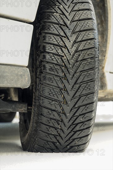 Winter tyre of a car on a snow-covered road