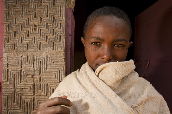 Orthodox novice outside the rock-hewn church of Mikael Imba