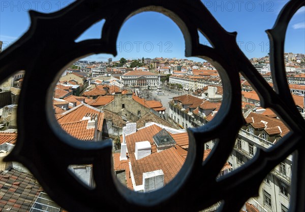 Outlook through a wrought iron grid of Santa Justa Elevator