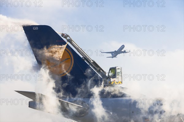 Tail unit of an Airbus A340 of Lufthansa airlines during de-icing at Frankfurt Airport